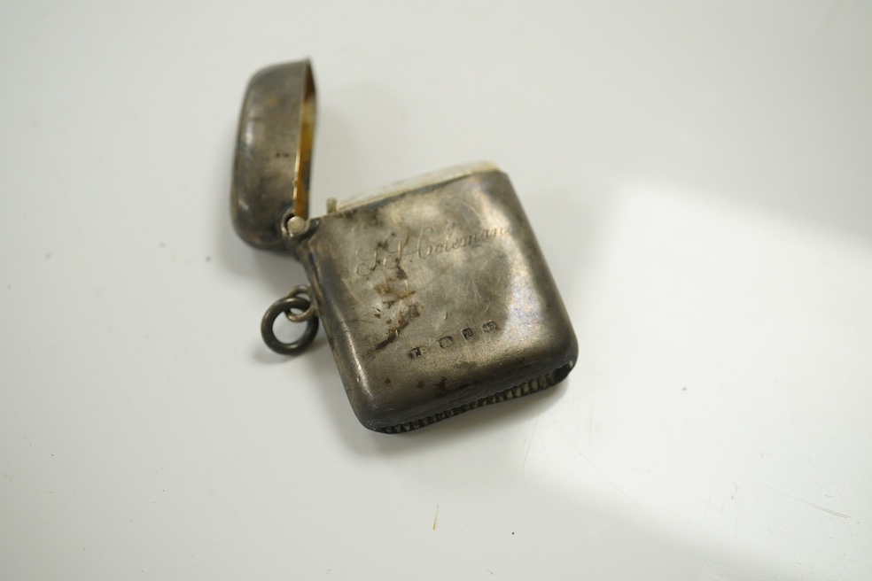 An Austrian 800 standard white metal matchbox holder, a 19th century continental white metal beaker, a modern silver mounted box cover and a silver vesta case. Condition - poor to fair